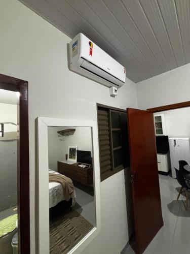 a room with a room with a bed and a mirror at Microcasa 02 in Tangara da Serra