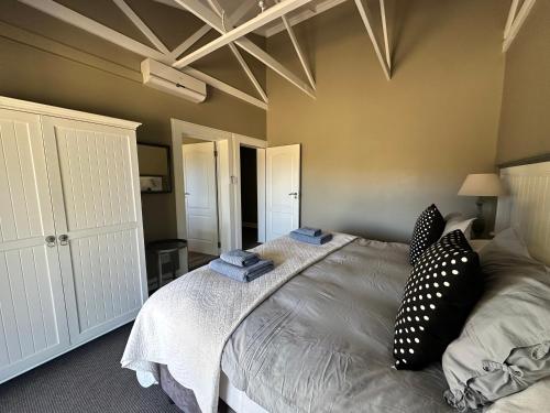 a bedroom with a large bed with pillows on it at Clarens Old Clubhouse in Clarens