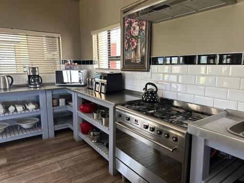 a kitchen with a stove top oven in a kitchen at Clarens Old Clubhouse in Clarens