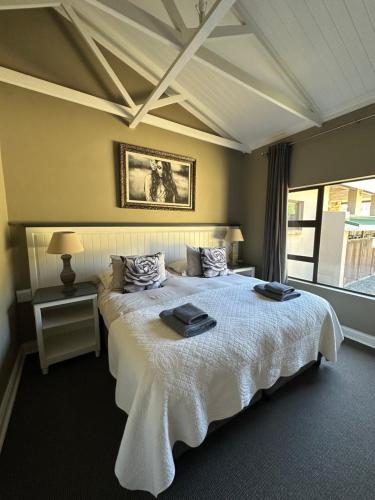 a bedroom with a bed with two trays on it at Clarens Old Clubhouse in Clarens