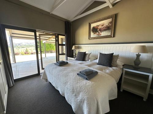 a bedroom with two beds with towels on them at Clarens Old Clubhouse in Clarens