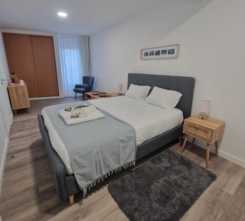 a bedroom with a bed with a tray on it at Cozy Dot Apartment in Ponta Delgada