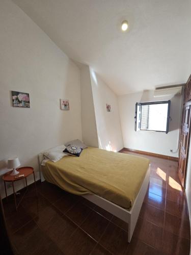 a small bedroom with a bed and a window at Nisa 2 Bedrooms AC Villa in Nisa