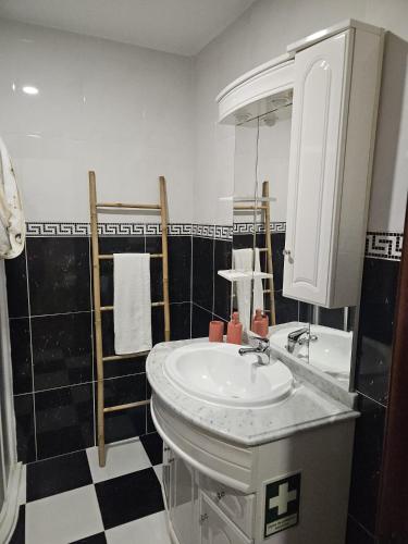 a bathroom with a sink and a mirror at Nisa 2 Bedrooms AC Villa in Nisa