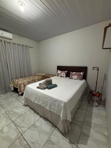 une chambre avec deux lits dans une pièce dans l'établissement Casa ampla e confortavel, à Tangará da Serra