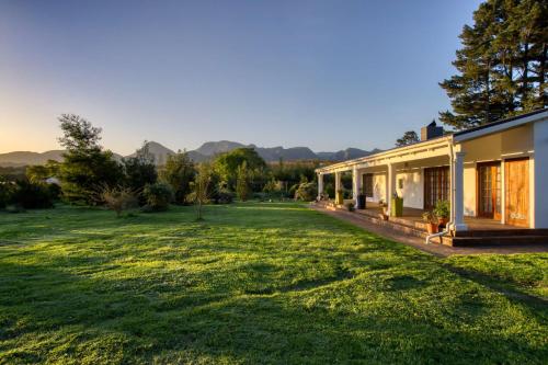 a house with a large yard next to a building at The Residence Boutique Hotel in Pineview