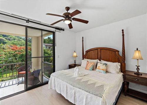 a bedroom with a bed with a ceiling fan and a balcony at Pacifico L1115 in Coco