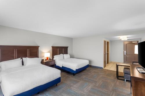 a hotel room with two beds and a desk at Hampton Inn University Area, Huntington, Wv in Huntington
