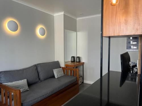 a living room with a couch and a television at Airfamily Congonhas in Sao Paulo