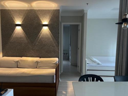 a living room with a couch and a bedroom at Airfamily Congonhas in Sao Paulo