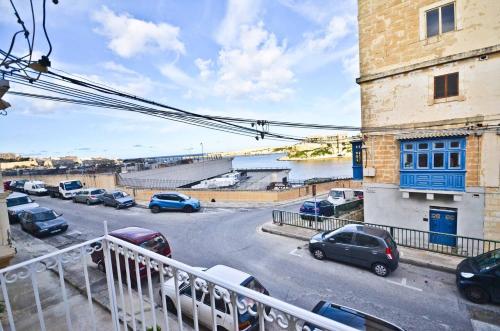 a balcony with cars parked in a parking lot at Eight Point Living Br6 in Birgu