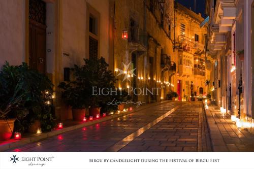 an empty city street at night with lights at Eight Point Living Br6 in Birgu