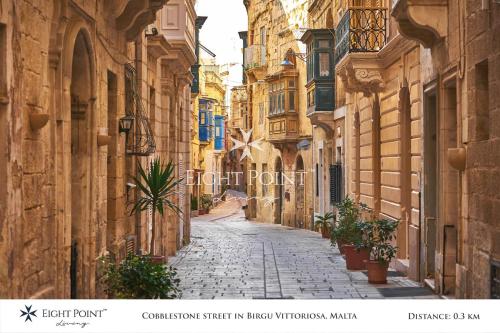 an alley in an old town with buildings at Eight Point Living Br6 in Birgu