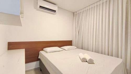 a bedroom with a bed with two towels on it at Miray Exclusive - Praia dos Carneiros in Praia dos Carneiros