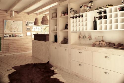 a kitchen with white cabinets and a rug at Barrica Lodge Hotel in Santa Cruz