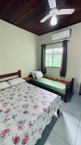 a bedroom with two beds and a window at Casa em bairro nobre de Prado in Prado