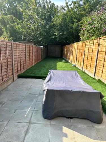 a mattress laying on the ground in a backyard at Eugino Properties in Grays Thurrock