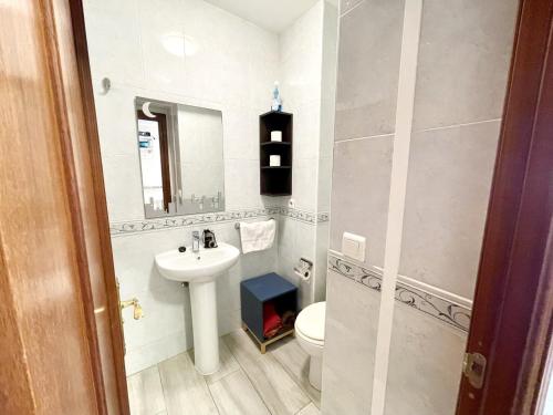 a bathroom with a sink and a toilet and a mirror at Estudio Benalmádena Costa in Benalmadena Costa
