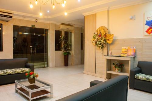 a lobby of a hospital with couches and a fireplace at Hotel Ipê in Belém