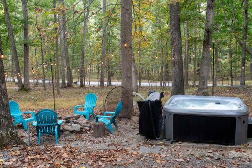 Great CacaponDog-Friendly w Hot Tub, Fire Pit & River Access的树林里的热水浴缸和椅子