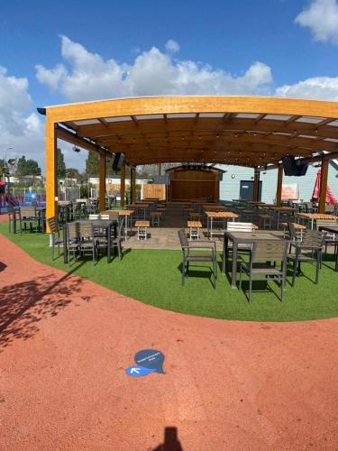 a group of tables and chairs on the grass at Stylish 3 Bedroom caravan near the Beach in Walton-on-the-Naze