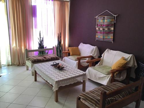 a living room with two chairs and a table at Lidas Sunny Guest House Argolis in Nafplio