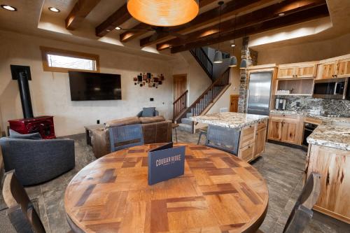 a kitchen with a wooden table in a room at Cougar Ridge Resort in Torrey