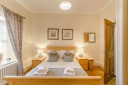 a bedroom with a bed with two towels on it at Waters Edge - Warkworth in Warkworth