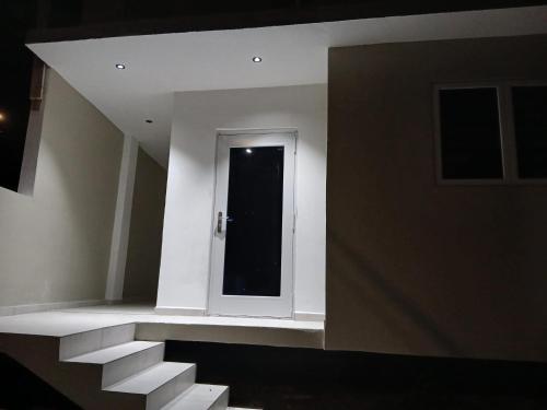 a hallway with a door and stairs in a building at JRMN Property in Sint Michiel