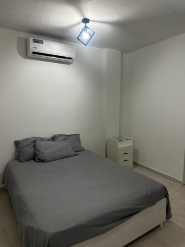 a bedroom with a bed and a light on the ceiling at JRMN Property - 5 minutes from Blue Bay beach, Boka Sami & Kokomo Beach in Dorp Sint Michiel