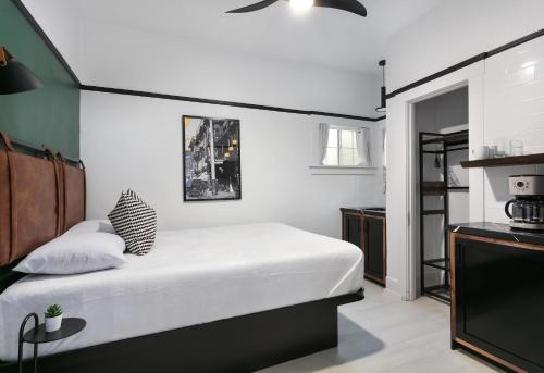 a bedroom with a bed and a flat screen tv at La Ventana in San Diego