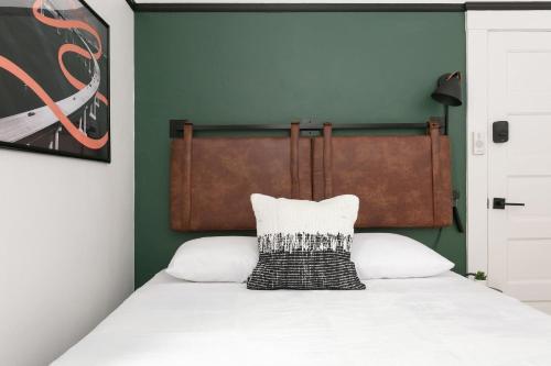 a bed with a black and white pillow on it at La Ventana in San Diego