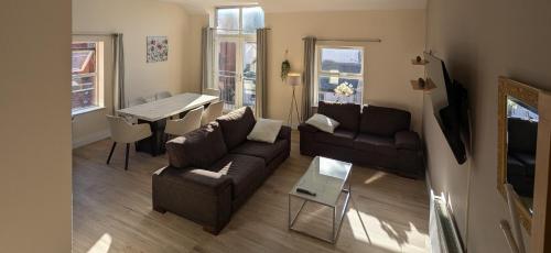 a living room with a couch and a table at City Centre A Apartment, 2nd Floor in Belfast