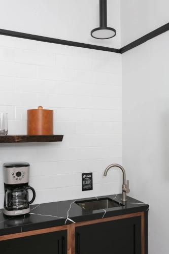 a kitchen counter with a sink and a coffee maker at La Ventana in San Diego