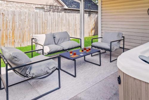 two chairs and a table on a patio at Endless Summer Retreat with Private Pool near Beach in Gautier