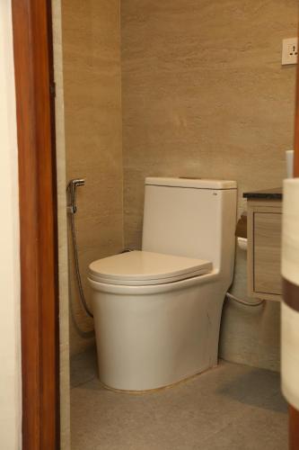 a bathroom with a white toilet in a room at Hotel Tapowan in Kathmandu