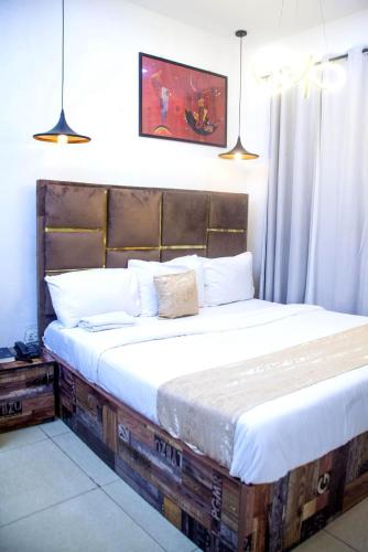 a bedroom with a bed made out of reclaimed wood at Ontario Suites in Lagos
