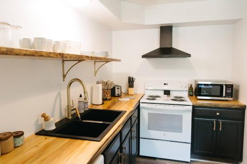 a kitchen with a white stove and a sink at "Morning View 1" Cozy Modern Stay - College/Hiking in Berea