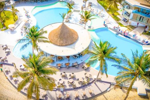an overhead view of a resort pool with palm trees at Kombo Beach Resort in Serekunda