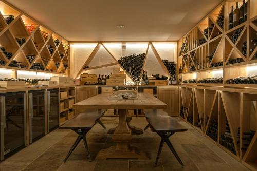 a wine cellar with a wooden table and chairs at Vila Zvonica - 3 minúty od Starý Smokovec in Nová Lesná