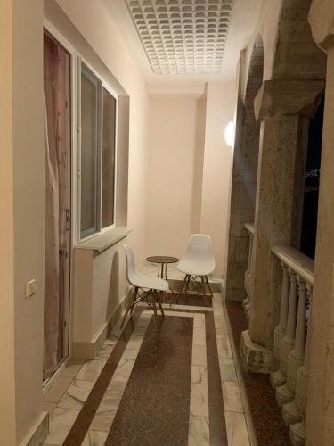 a room with two chairs and a table and a window at Guest House Lilia in Yerevan