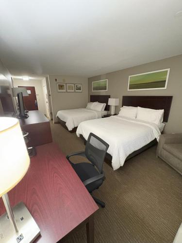 a hotel room with two beds and a couch at Holiday Inn Express Hotel & Suites Lafayette by IHG in Lafayette