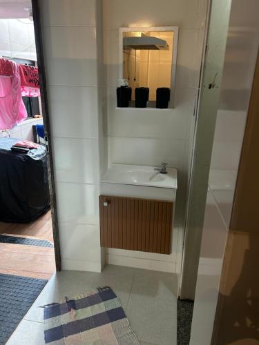 a bathroom with a sink and a mirror at Casa da Amanda in São Thomé das Letras