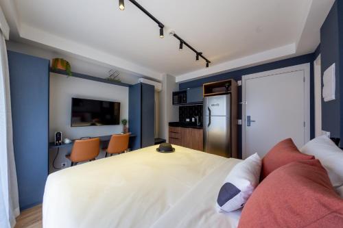 a bedroom with a large white bed and blue walls at House of Charlie Paraiso in Sao Paulo
