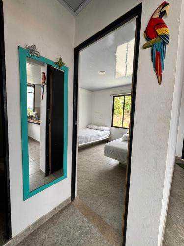 a room with a mirror and a bedroom with a bed at Entre Montañas in Vergara