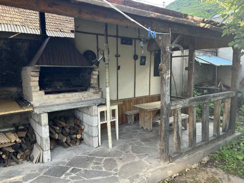 an outdoor oven with a table and a bench at Սեփական տուն in Vanadzor