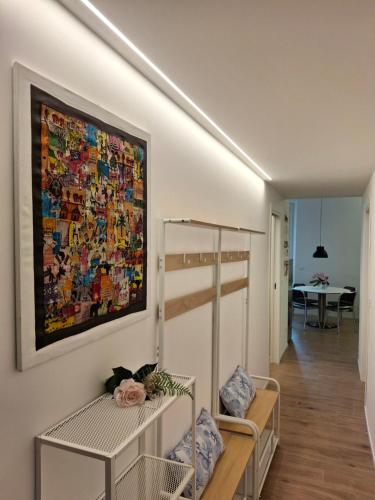 a living room with a painting on the wall at SIMARE - 2 camere matrimoniali a 500metri da stazione e spiaggia in Sestri Levante
