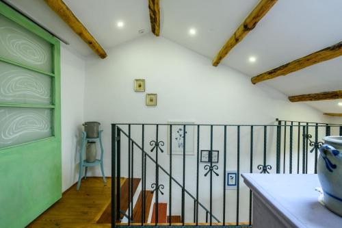 a room with white walls and a green door at Holiday Home Ladonja in Manjadvorci