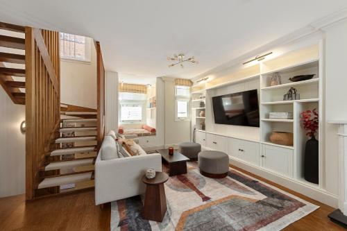 a living room with a couch and a tv at Charming Family Retreat 4BR Marylebone in London