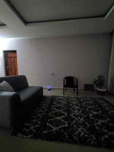 a living room with a couch and a chair at Faraja Homestay Mwanza in Mwanza